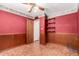 A bedroom with paneling and colorful walls, with a ceiling fan and shelves at 2114 E Hale St, Mesa, AZ 85213