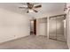 A standard bedroom with a ceiling fan and closet at 2114 E Hale St, Mesa, AZ 85213