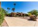 Expansive driveway leading to a single-story home with desert landscaping and tall, eye-catching palm trees at 2114 E Hale St, Mesa, AZ 85213