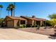 A charming brick home with a two-car garage, desert landscaping, and a long driveway sits on a sunny street at 2114 E Hale St, Mesa, AZ 85213