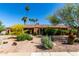 Charming single-story brick home featuring a well-maintained landscape with beautiful desert plants and tall palm trees at 2114 E Hale St, Mesa, AZ 85213