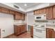 Well-lit kitchen features wooden cabinets, modern appliances, and sleek countertops for a functional cooking space at 2114 E Hale St, Mesa, AZ 85213