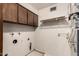 A functional laundry room features upper cabinets and utility hookups at 2114 E Hale St, Mesa, AZ 85213