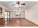 Open living area with hardwood floors, a ceiling fan, and access to a patio through sliding glass doors at 2114 E Hale St, Mesa, AZ 85213