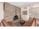 Inviting living area with a charming brick fireplace, plush seating, and elegant lighting fixtures at 2114 E Hale St, Mesa, AZ 85213
