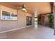 A covered outdoor patio area with brick detail and ceiling fan at 2114 E Hale St, Mesa, AZ 85213