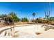 A fenced empty pool features a tile trim and desert trees at 2114 E Hale St, Mesa, AZ 85213