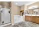 Bright bathroom with a soaking tub, a glass-enclosed shower, and a dual sink vanity at 2189 W Mila Way, San Tan Valley, AZ 85144