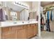 Bathroom featuring double sinks and a walk-in closet for ample storage at 2189 W Mila Way, San Tan Valley, AZ 85144