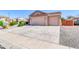 Wide driveway leading to a two-car garage, enhancing curb appeal and providing ample parking space at 2189 W Mila Way, San Tan Valley, AZ 85144