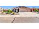 Charming single-story home showcasing a landscaped front yard and a spacious three-car garage at 2189 W Mila Way, San Tan Valley, AZ 85144