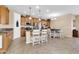 Spacious kitchen with wood cabinets, stainless appliances, island, and cozy dining area at 2189 W Mila Way, San Tan Valley, AZ 85144