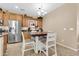 Kitchen area with wood cabinets, stainless steel appliances, and a dining table at 2189 W Mila Way, San Tan Valley, AZ 85144