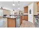 Open kitchen with a large island, stainless steel appliances, and adjacent living space at 2189 W Mila Way, San Tan Valley, AZ 85144