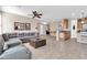 Large living room featuring a comfortable sectional sofa and neutral tile flooring at 2189 W Mila Way, San Tan Valley, AZ 85144