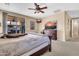 Bright main bedroom with patio access, wood furniture, and ceiling fan at 2189 W Mila Way, San Tan Valley, AZ 85144