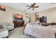 Comfortable main bedroom with wood furniture, a ceiling fan, and warm lighting at 2189 W Mila Way, San Tan Valley, AZ 85144