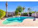 Backyard view of an in-ground swimming pool with well-manicured landscaping and mature shade trees at 2189 W Mila Way, San Tan Valley, AZ 85144