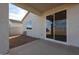 View of the back patio area featuring a sliding glass door and small yard at 22045 N Rummler Ln, Maricopa, AZ 85138