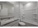 Bathroom features a granite countertop, white cabinets, and a tub with shower at 22045 N Rummler Ln, Maricopa, AZ 85138