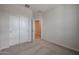 Carpeted bedroom with closet and door leading to another room at 22045 N Rummler Ln, Maricopa, AZ 85138