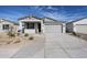 Charming single-story home featuring a two-car garage and low maintenance desert landscaping at 22045 N Rummler Ln, Maricopa, AZ 85138