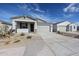 Charming single-story home featuring a two-car garage and low maintenance desert landscaping at 22045 N Rummler Ln, Maricopa, AZ 85138