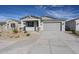 Charming single-story home featuring a two-car garage and low maintenance desert landscaping at 22045 N Rummler Ln, Maricopa, AZ 85138