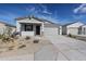 Charming single-story home featuring a two-car garage and low maintenance desert landscaping at 22045 N Rummler Ln, Maricopa, AZ 85138