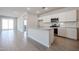Bright, open kitchen featuring an island and stainless steel appliances and access to an outdoor area at 22045 N Rummler Ln, Maricopa, AZ 85138