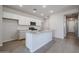 Bright kitchen with white cabinets, a large island, and stainless steel appliances at 22045 N Rummler Ln, Maricopa, AZ 85138