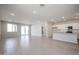 Open concept living room with tile floors and large windows, with access to an outdoor area at 22045 N Rummler Ln, Maricopa, AZ 85138