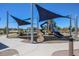 Community playground featuring a slide, climbing structure, and shaded seating at 22045 N Rummler Ln, Maricopa, AZ 85138