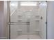 All-white shower with built-in shelves and a clear glass door at 22045 N Rummler Ln, Maricopa, AZ 85138
