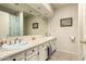 Well-lit bathroom featuring dual sinks, bright tile, and recessed lights at 2322 S Rogers -- # 1, Mesa, AZ 85202