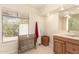 Bright bathroom with a large window, vanity, and a framed mirror with built in lighting at 2322 S Rogers -- # 1, Mesa, AZ 85202