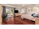 Spacious bedroom with a ceiling fan, sliding glass door, and wood floors throughout at 2322 S Rogers -- # 1, Mesa, AZ 85202