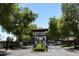 Elegant gated community entrance with manicured landscaping, providing privacy and security for residents at 2322 S Rogers -- # 1, Mesa, AZ 85202