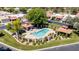Aerial view of the community pool surrounded by wrought iron fencing, greenery, and small shade structures at 2322 S Rogers -- # 1, Mesa, AZ 85202