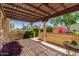 Relaxing covered patio area with a pergola, stone flooring, and garden views, ideal for outdoor dining and entertaining at 2322 S Rogers -- # 1, Mesa, AZ 85202