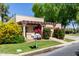 Inviting home with vibrant yellow and pink flowers framing the entrance and lush green lawn, showcasing a well-cared-for exterior at 2322 S Rogers -- # 1, Mesa, AZ 85202
