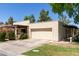 Exterior shot of this beautiful house featuring a two-car garage, manicured lawn, and an appealing neutral color palette at 2322 S Rogers -- # 1, Mesa, AZ 85202