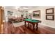 Open-concept game and dining room with a pool table, dining table, and views of backyard at 2322 S Rogers -- # 1, Mesa, AZ 85202