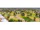 Scenic aerial shot of lush golf course featuring mature trees, winding walkways, and a pond at 2322 S Rogers -- # 1, Mesa, AZ 85202