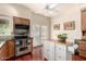 Open concept kitchen with stainless steel appliances, tile backsplash, kitchen island, and backyard views at 2322 S Rogers -- # 1, Mesa, AZ 85202