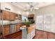 Bright kitchen with stainless steel appliances, wooden cabinets, tile backsplash and center island at 2322 S Rogers -- # 1, Mesa, AZ 85202