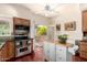 Open kitchen with stainless steel appliances, a white island, and access to a cozy patio at 2322 S Rogers -- # 1, Mesa, AZ 85202