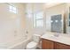 Bright bathroom featuring a shower-tub combo and a single sink at 2323 W Kachina Trl, Phoenix, AZ 85041