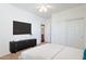 This bedroom features a wall-mounted television and sliding closet doors at 2323 W Kachina Trl, Phoenix, AZ 85041