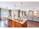 Open-concept kitchen with a granite island flowing into the living and dining spaces at 2323 W Kachina Trl, Phoenix, AZ 85041